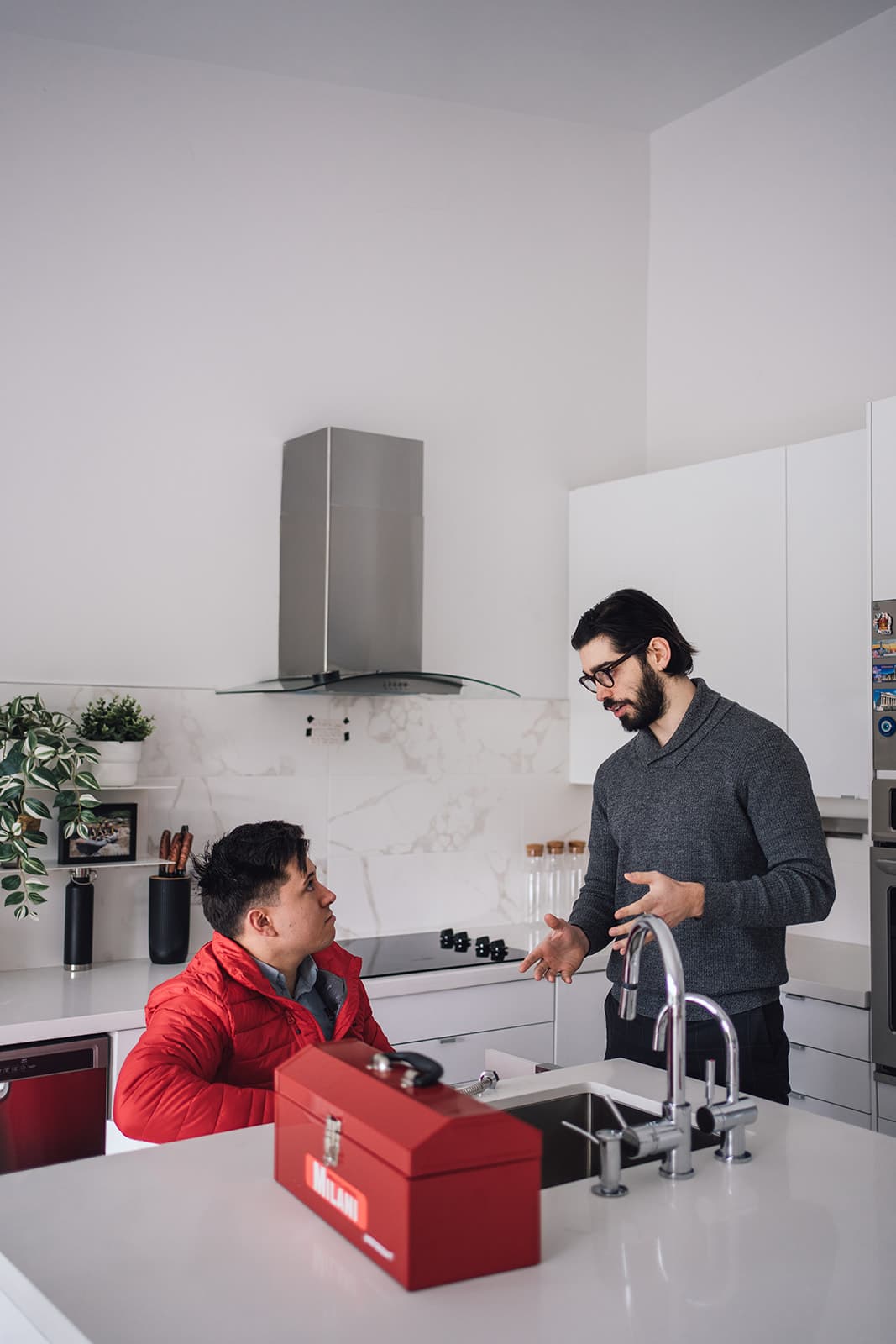 Milani plumbing technician at a customer's kitchen sink